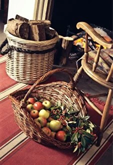 Indoor Collection: Big decorative basket of Coxs apples with sprays of ornamental berries by open fireplace