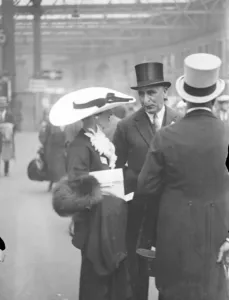 The biggest at Ascot. An outsized hat worn by a women racegoer as she left Waterloo for Ascot