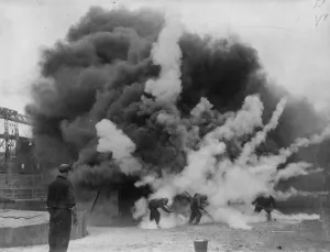 A bomb that puts out fires demonstrated at Clapton Stadium. A blazing building