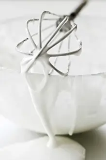 Cook Prints: Bowl of white icing with dripping balloon whisk credit: Marie-Louise Avery / thePictureKitchen