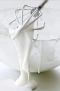 Cook Prints: Bowl of white icing with dripping balloon whisk credit: Marie-Louise Avery / thePictureKitchen