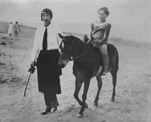 A boy King at the seaside. The young King Michael of Rumania takes a donkey ride at Mamaia