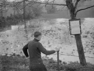 A boy looks at the flooded Sidcup swimming pool - flooded due to the bad weather