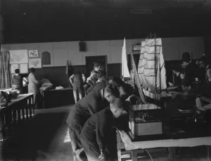 Boys examine a model sailing ship at the handicraft exhibition in Dartford, Kent