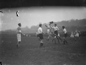 Game Prints: Boys football, two players compete for an aerial ball. 1935