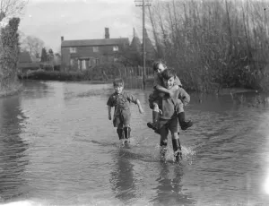 Boys wade through the floods in Beltring, Kent. 1936