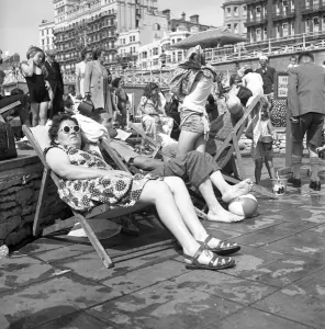 Beach Prints: Brighton Enjoying the sunshine in Brighton relaxing in a deckchair 1950