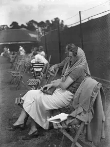 Sitting Prints: At the Brockenhurst Junior Tennis Tournament, Mrs Paul Peatling watches a match. 1937