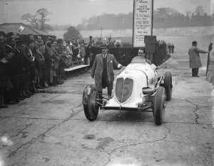 Brooklands races. Photo shows; Mr Whitney Straight driving his car back from the track