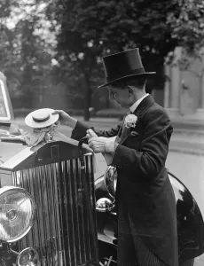 Bryan Adams, a Harrow boy with a Harrow hat car mascot at Lords where the Eton