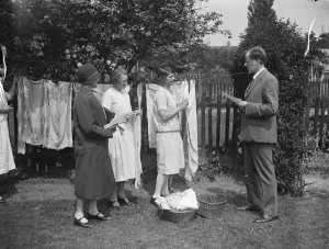 Domestic Prints: Canvassing on washing day. Mr Comyns Carr, KC, the Liberal candidate seeks