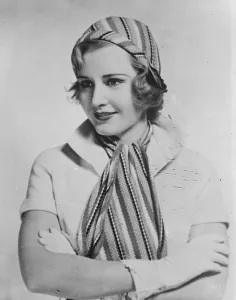Cap and scarf to match for sports. The latest thing in sportswear worn by Madge