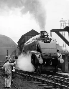 The Capitals Limited steam locomotive sets off from Kings Cross Station, London