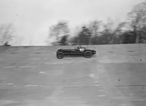 Captain Sir Henry Birkin in his car speeding around the Brooklands track