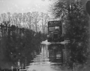 A Carter Paterson express carrier lorry driving through the flooded roads near Darenth