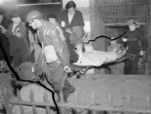 Casualties are being loaded into the back of a lorry during an air raid drill