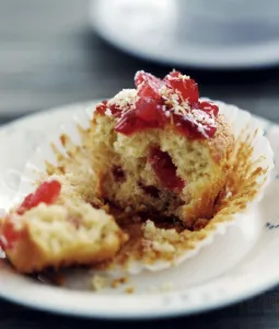Cooking Prints: Cherry muffin broken open on white plate credit: Marie-Louise Avery / thePictureKitchen