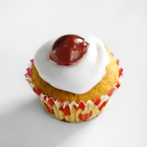 Cherry topped mini muffins on white background credit: Marie-Louise Avery / thePictureKitchen