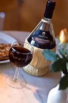 Straw Prints: Chianti classico in traditional old fashioned raffia covered bbottle on restaurant