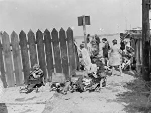 Playing Collection: Children have come to the riverside on the Thames estuary at Gravesend, Kent, to
