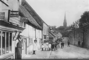 Edwardian Times Prints: Children posing in the street along North Street, Petworth, West Sussex, England