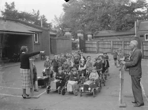 Teacher Prints: Children receive traffic instructions on the playground of their Sidcup Hill School