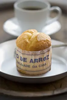 Classic Portuguese muffin type cake made with rice in paper wrapper on metal plate