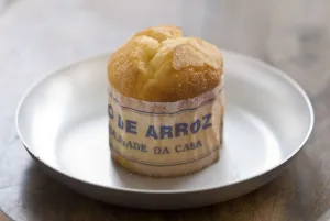 Classic Portuguese muffin type cake made with rice in paper wrapper on metal plate