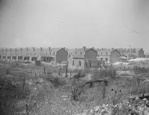 Coal from war wrecked coalfield of Lens. Rows of newly constructed miners dwellings