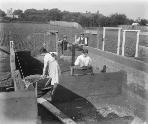 Concrete Houses at Harlow, Essex Compressing cement in the mould, in the background