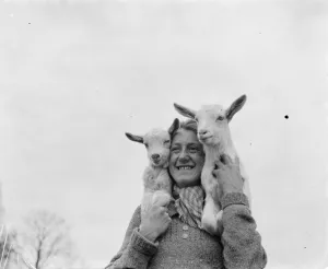 Connie Gurney holding a pair of kids at a goat farm in birling, Kent, 1939