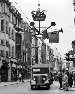 Coronation decorations go up and this shows something of the motie in Old Bond Street