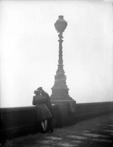 London Prints: Couple arm in arm leaning over bridge in London in fog 1940s love couple romance