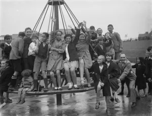 Playing Prints: Crayford playground is opened. Children swing on the maypole swing