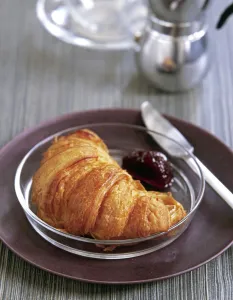 Knife Prints: Croissant on glasss plate with cherry jam credit: Marie-Louise Avery / thePictureKitchen