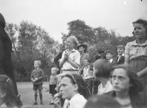 The crowd watching a trapeze artist performing at the Sidcup fete in Kent