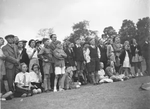 The crowd watching a trapeze artist performing at the Sidcup fete in Kent