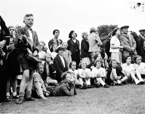 The crowd watching a trapeze artist performing at the Sidcup fete in Kent