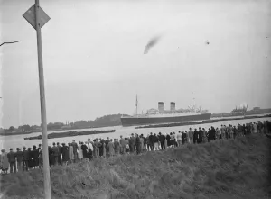 Crowds gather on the bank of the Thames estuary at Long Reach in Dartford, Kent