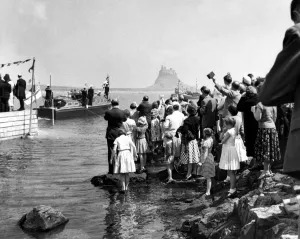 English Prints: Crowds line the shore on Holy Island as the royal barge approaches the landing stae