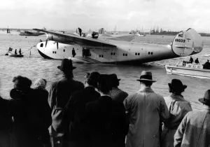 International Herald Tribune Prints: Crowds meet the giant new American flying boat Yankee Clipper as she moors