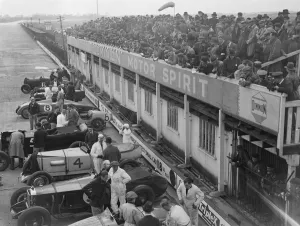Crowds throng Brooklands for great Easter opening meeting. Easter holiday crowds