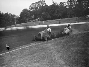 The Crystal Palace miniature car racing grand prix. The cars take the bend. 1938