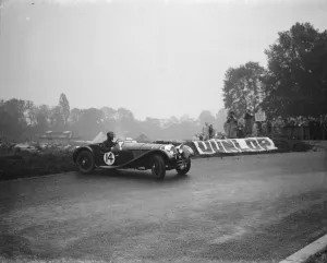 Spectators Prints: The Crystal Palace road racing. A D Taylor spins his car out. 1938