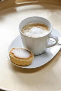 Caffeine Prints: Cup of cappuccino with spiral of cocoa dusted on top with a mazarin - Swedish almond