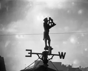 Quirky Prints: A curious sign forming a weather vane is to be seen on the roof of the Champion