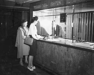 Customers at Midland Bank being attended to by a Bank Teller. 23 October 1946