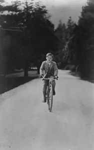 A cycling King. King Michael of Romania cycling in the grounds of his Palace at Sinaia