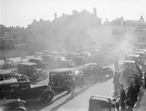 The Dartford Carnival. Carnival goers cars parked near the procession