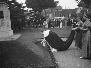 Costumes Prints: The Dartford Carnival. The Dartford queen laying a wreath at the memorial